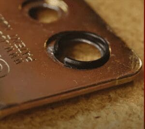 A close up of a metal plate with a ring on it.