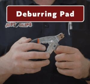 Person holding pliers with deburring pad